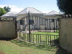 an iron gate in front of a house