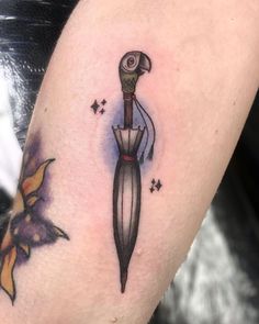 a tattoo on the arm of a woman with an umbrella and stars around her neck