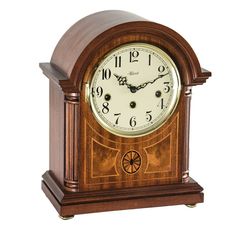 a wooden clock with roman numerals on the front and sides, sitting upright