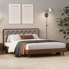 a bedroom with a bed, nightstands and plants