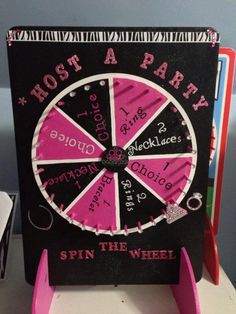 a pink and black spinning wheel with writing on it