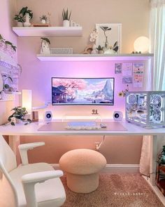 a white desk with a computer on top of it in front of a pink wall