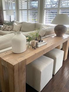 a living room filled with furniture and large windows