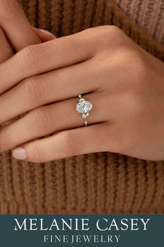 a woman's hand with a ring on her finger and the words melanie casey fine jewelry