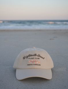 Inspired by North Carolina's east coast summers. Floating in the intercostal with sandy toes & sun-kissed skin. A beige cap with, dark brown embroidery, and a luxe satin interior lining. Beach Floats, Beige Cap, Brown Embroidery, Winter Headwear, Wrightsville Beach, Dad Cap, Dad Caps, Cayman Islands, British Indian Ocean Territory