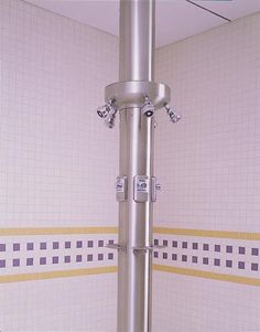 there is a pole in the bathroom with two faucets attached to it's sides