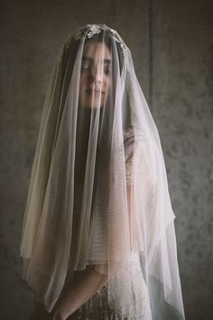 a woman wearing a veil and wedding dress