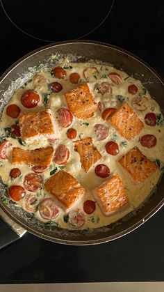 a pan filled with food sitting on top of a stove