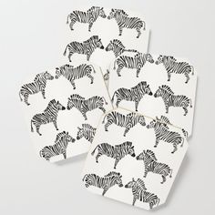 four zebra coasters with black and white designs on them, all in the same pattern