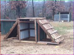 an outdoor chicken coop made out of wood