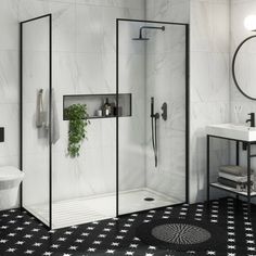 a bathroom with a checkered tile floor and walls, including a walk in shower