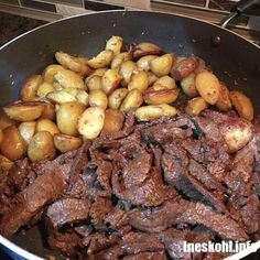 steak and potatoes in a pan on the stove