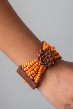 Held together by oversized rectangular fittings and wooden floral frames, strands of refreshing orange wooden beads are threaded along stretchy bands that weave around the wrist for a colorful island inspired look.

Sold as one individual bracelet. Wooden Bag, Floral Frames, Orange Bracelet, Wooden Bracelet, Wood Bracelet, Paparazzi Accessories, Flower Bracelet, Paparazzi Jewelry, Boutique Jewelry