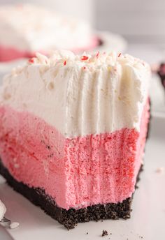 a slice of cake with white and pink frosting