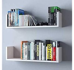 two white shelves with books and magazines on them