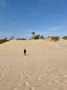 a person standing on top of a sandy hill