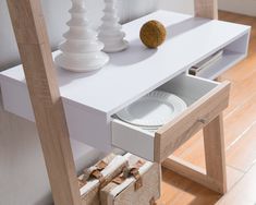 a white table with drawers and plates on it