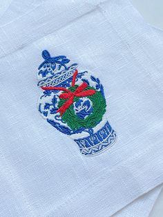 a white shirt with an embroidered crest on it