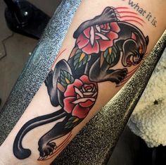 a black panther with roses on its back leg and the words what it is written below