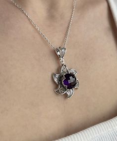 "Amethyst Silver Lotus Statement Pendant Necklace, 925 Sterling Silver Artisan Handmade Filigree Victorian Woman Floral Pendant Jewelry February necklace, birthstone necklace, Violet Gemstone, women pendant jewel, purple stone pendant, anniversary gift her Gemstone: Amethyst 12 mm. Amethyst is the birthstone for the month of February. The name \"amethyst\" is derived from the Greek words \"amethystos,\" meaning \"not intoxicated.\" In ancient times, people believed that wearing amethyst or drinking from amethyst vessels could prevent intoxication. Material: 925 Sterling Silver ( NICKEL FREE ) Chain Length:  -21 Inches ( 53 cm ) -18 Inches + 2 Inches Extender ( 46 cm + 5 cm Extender ) Pendant height and width: -1.6 Inches X 1 Inches // 4cm X 2.5cm Unveil the allure of our Amethyst Silver Lo Purple Sterling Silver Filigree Jewelry, Sterling Silver Purple Jewelry With Intricate Design, Purple Sterling Silver Jewelry With Intricate Design, Sterling Silver Jewelry With Intricate Design In Purple, Purple Pendant Necklace With Filigree, Purple Filigree Pendant Necklace, Purple Filigree Pendant Jewelry, Ornate Purple Gemstone Necklaces, Round Amethyst Filigree Jewelry