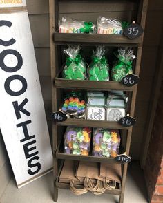 a shelf filled with lots of items next to a sign