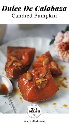 a white plate topped with pieces of cake covered in caramel sauce and almonds