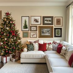 a living room with a christmas tree in the corner and pictures on the wall above it