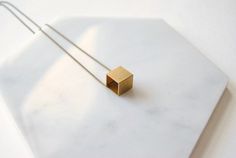 A simple vintage cube charm (12 mm wide) that I strung directly onto a nickel free aged-brass chain. It looks cool on its own, but you could also layer it because of how minimal it is. It’s fun to wear because it’s such a recognizable shape, but how often do you see it in jewelry? The charm you receive will have slight age spots, making each one unique.  It looks vintage because it is!*If you prefer a different length, just let me know during checkout!*► DETAILS:Chain length: 24 inches (61 cm)Pe Minimalist Square Metal Jewelry, Minimalist Brass Square Pendant Jewelry, Minimalist Brass Necklace With Square Pendant, Minimalist Nickel-free Square Pendant Jewelry, Minimalist Rectangular Brass Jewelry, Cube Necklace, Chevron Necklace, Cute Box, Bezel Pendant