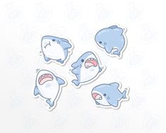 four stickers with shark faces on them, one has an open mouth and the other has