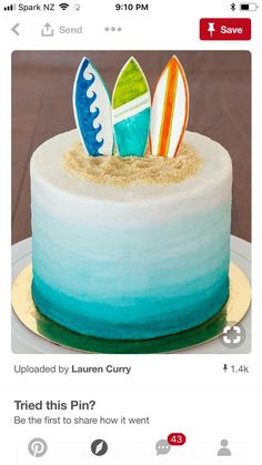 the cake is decorated with surfboards and sand on it's top, as well as an instagram