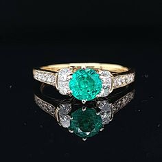 Gorgeous 18k Yellow gold ring natural green Emerald, Center round shape weight 0.92ct. size 5.9m very nice rich medium green color nice luster lively,brilliant stone and clean. side diamonds total weight 0.50ct. SI1-G ring size 7.5 Resizable Retail value $6,500 net . Appraisal available Green Diamond Ring Fine Jewelry, Green Diamond Ring With Brilliant Round Cut, Green Diamond Ring With Brilliant Cut, Green Diamond Cluster Ring, Classic Green Round Cut Diamond Ring, Green Diamond Birthstone Ring, Classic Green Diamond Round Ring, Classic Round Green Diamond Ring, Emerald Green Diamond Ring With Brilliant Cut