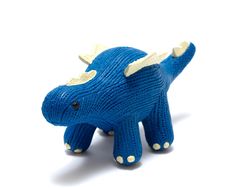 a knitted blue triloon toy on a white background