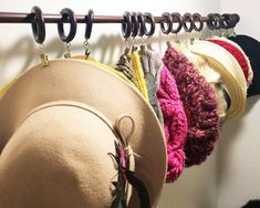 several hats are hanging on a coat rack