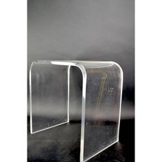 two acrylic side tables sitting next to each other on a black table top