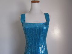 "This is a Stunning Vintage by Designer NITELINE Blue Green Teal Mermaid Sequin Square Neckline Sleeveless Evening Party Dress Size 8 S-M All measurements are approximate: Armpit to armpit 16\" length 36\" ( from shoulder to hem) This fabulous mini dress is in very good vintage condition with very little sign of wear, and ready to wear. Material: 100% Polyester, Sequins For more beautiful and fabulous of vintage Dresses Handbags and Accessories please see our \"Handbags Accessories clothing\" Sh Fitted Sleeveless Mermaid Dress, Blue Sequined Mermaid Dress, Blue Mermaid Dress For Spring Party, Blue Mermaid Dress For Summer, Sleeveless Summer Mermaid Prom Dress, Sleeveless Fitted Mermaid Party Dress, Blue Sequined Mermaid Dress For Night Out, Spring Sleeveless Stretch Mermaid Dress, Blue Stretch Mermaid Dress For Evening