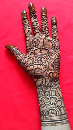 the hand is decorated with intricate designs on it