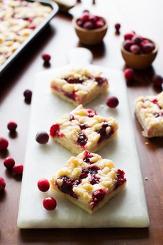 cranberry and white chocolate squares on a cutting board