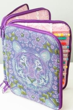 two purple zippered pouches filled with pencils