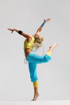 a young woman is doing a handstand in the air with her legs spread out