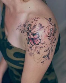 a woman with a butterfly and flowers tattoo on her shoulder