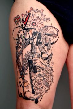 a woman's thigh with tattoos on it