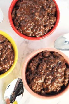 two bowls filled with chocolate oatmeal sitting on top of a white counter