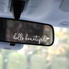 a car mirror with the words hello beautiful written on it