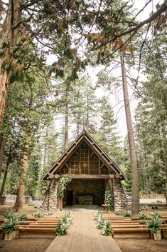 an outdoor chapel surrounded by trees and benches