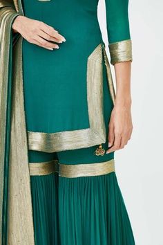 Emerald green straight short kurta with placement gold-tone sequin work. Comes with embroidered sharara pants and dupatta.
Component: 3
Embroidered
Neckine: Mandarin Collar
Sleeve Length: Three Quarter
Fabric: Chiffon
Color: Green
Side slits
Keyhole neck - Aza Fashions Reception Palazzo Set With Gold Embroidery, Green Sharara With Straight Kurta For Reception, Traditional Palazzo Set With Gold Embroidery For Reception, Green Chinon Palazzo Set For Reception, Festive Semi-stitched Palazzo Set With Gold Embroidery, Fitted Gold Embroidery Palazzo Set, Diwali Georgette Sets With Gold Embroidery, Diwali Sharara With Gold Embroidery In Georgette, Festive Georgette Sharara With Gold Embroidery