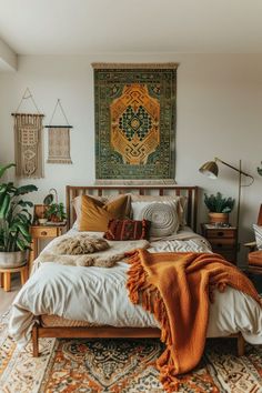 a bedroom with a bed, rugs and pictures on the wall above it is decorated in neutral colors