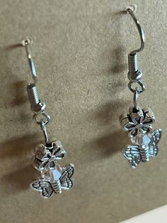 These silver earrings show off a cute butterfly with a soft pink bead. They are hanging earrings perfect to pair with a beautiful spring dressflowers two ways.   No returns on earrings. Silver Butterfly Charm Drop Earrings, Silver Dangle Flower Earrings Feminine, Feminine Silver Dangle Flower Earrings, Feminine Hypoallergenic Silver Earrings, Silver Butterfly Charm Earrings For Party, Cute Silver Flower Earrings, Feminine Silver Flower Drop Earrings, Feminine Silver Drop Flower Earrings, Feminine Silver Dangle Earrings