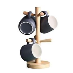 two mugs are hanging from a wooden rack with three cups on the top and bottom