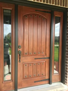 the front door is made of wood and has two sidelights on each side,