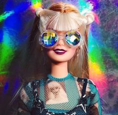 a barbie doll with sunglasses on her head and hair in the middle of it's face